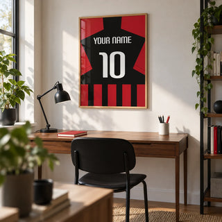 Football Shirt Poster in Black and Red Stripes, framed on the wall of a tidy young adult's home study with a white wall and a slim walnut desk