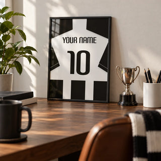 Football Shirt Poster in Black and White Stripes with Black Sleeves, a small A4 framed print leaning on a walnut desk