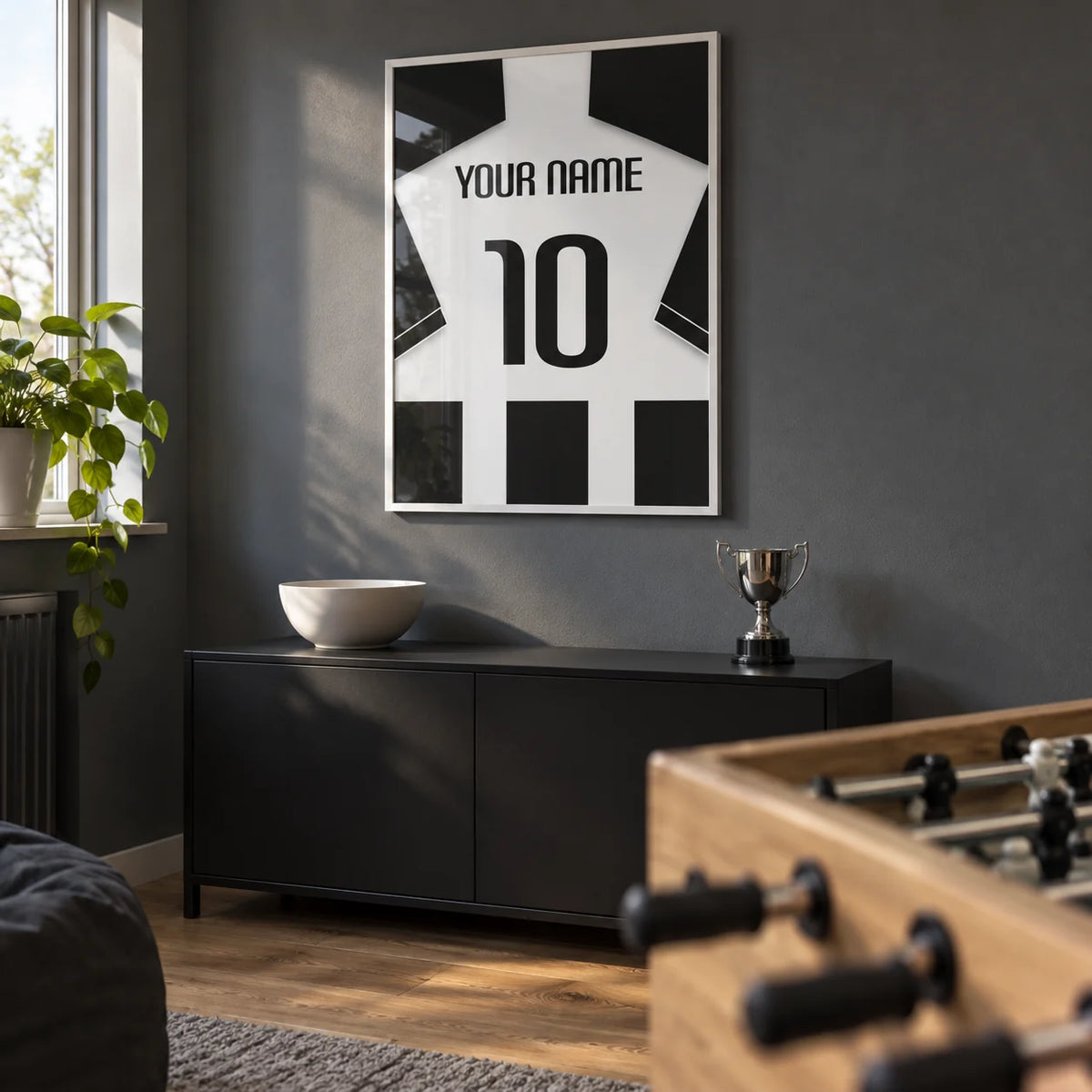 Football Shirt Poster in Black and White Stripes with Black Sleeves, framed on the wall of a small football fan's games room in a UK semi-detached house