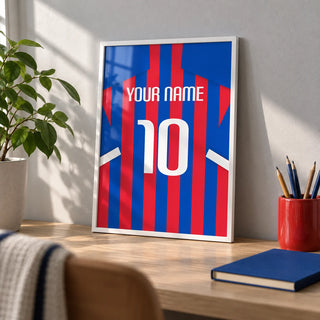 Football Shirt Poster in Blue and Red Stripes, a small A4 framed print leaning on a pale oak desk