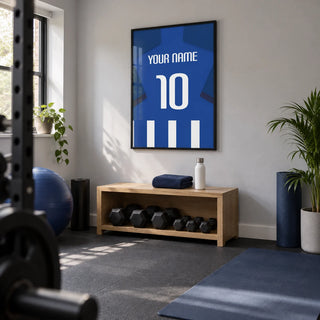 Football Shirt Poster in Blue and White Stripes with Dark Blue Sleeves, framed on the wall of a small converted spare-room home gym in a UK house with pale grey walls and plain dark rubber flooring