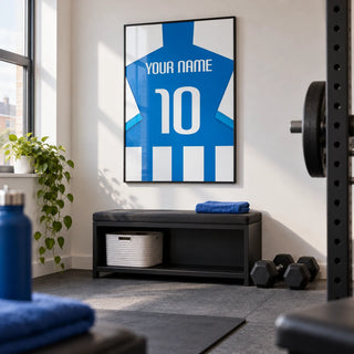 Football Shirt Poster in Blue and White Stripes with Striped Sleeves, framed on the wall of a compact home gym in a converted UK spare room with white walls and plain grey rubber flooring