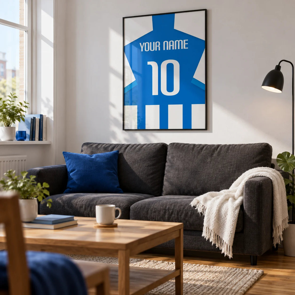 Football Shirt Poster in Blue and White Stripes with Striped Sleeves, framed on the wall of a crisp living room in a football fan's first UK flat (22-28) with white walls and a warm wood floor