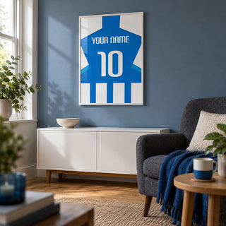 Football Shirt Poster in Blue and White Stripes with Striped Sleeves, framed on the wall of a small football matchday snug in a UK terraced house with a muted blue wall and oak floor in a living room
