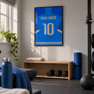 Football Shirt Poster in Blue with Beige Number, framed on the wall of a compact home gym in a UK spare room with light grey walls and plain charcoal rubber flooring