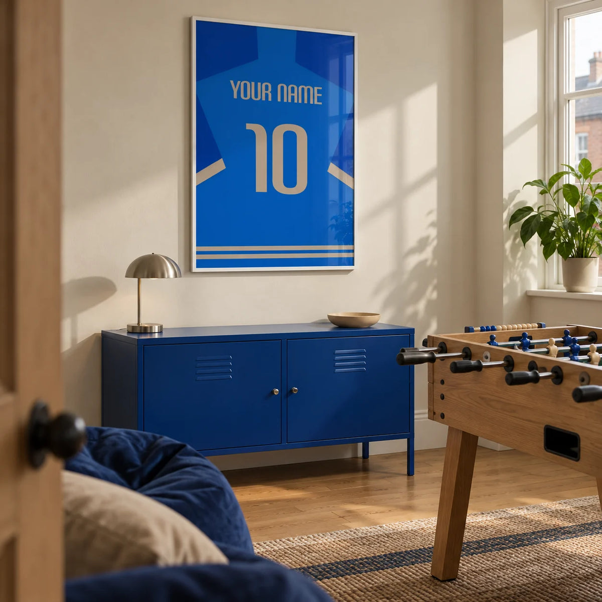 Football Shirt Poster in Blue with Beige Number, framed on the wall of a small football-themed games room in a UK terrace with a pale beige wall and oak floor in a home office