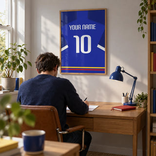 Football Shirt Poster in Blue with White Sleeve Stripe, framed on the wall of a compact home study in a UK terraced house with a pale grey wall