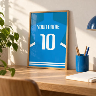 Football Shirt Poster in Bright Blue with White Number, a small A4 framed print leaning on an oak desk