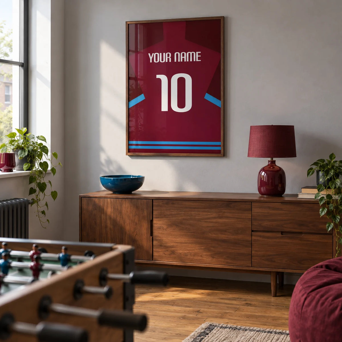 Football Shirt Poster in Claret with Light Blue Sleeve Trim, framed on the wall of a modern football fan's games room in a UK terraced house with a pale grey wall in a living room