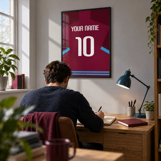 Football Shirt Poster in Claret with Light Blue Sleeve Trim, framed on the wall of a tidy home study for a young adult football supporter with a pale grey wall