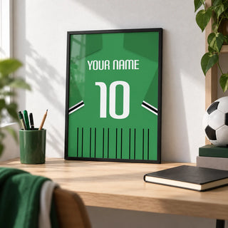 Football Shirt Poster in Green with Black and White Sleeve Stripes, a small A4 framed print leaning on a pale oak desk