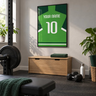 Football Shirt Poster in Green with Dark Green Sleeves, framed on the wall of a compact home gym in a converted UK spare room with light grey walls and plain rubber flooring
