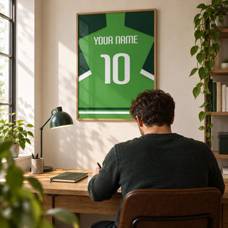 Football Shirt Poster in Green with Dark Green Sleeves, framed on the wall of a tidy home study for a football fan (22-35) in a UK first flat with a warm white wall