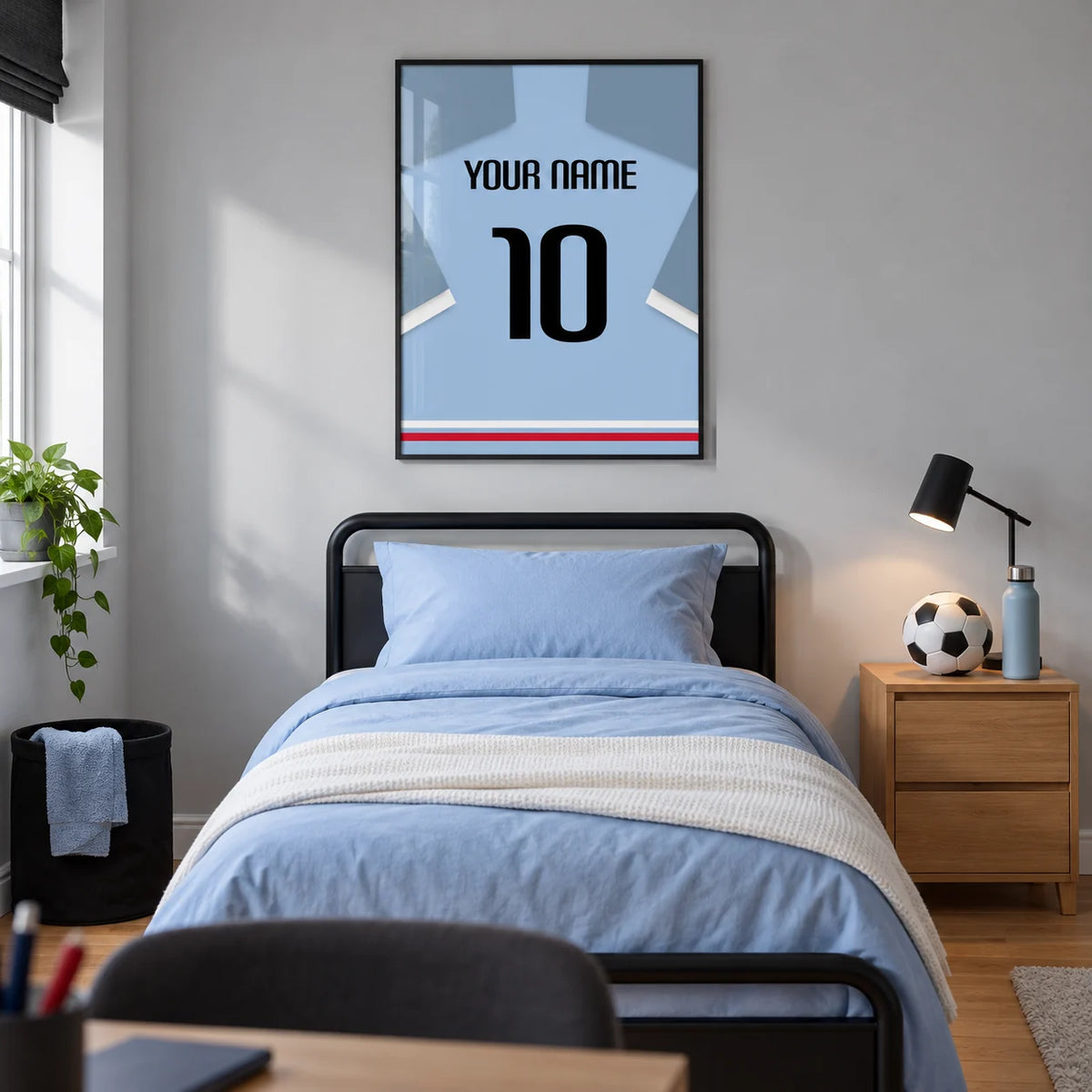 Football Shirt Poster in Light Blue with Black Number, framed on the wall of a modern football-loving teenager's single bedroom (13-17) in a UK family home with a pale grey wall and oak floor