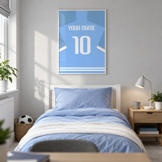 Football Shirt Poster in Light Blue with White Sleeve Stripes, framed on the wall of a modern football-loving teenager's single bedroom (13-17) in a UK family home with a pale grey wall
