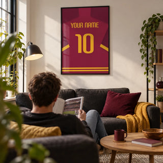 Football Shirt Poster in Maroon with Yellow Number, framed on the wall of a contemporary football fan's living room in a first flat (22-28) with a warm white wall