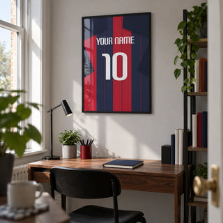 Football Shirt Poster in Navy and Red Stripes, framed on the wall of a young adult's tidy home study in a UK terrace with a light grey wall and a slim black task lamp