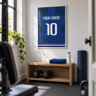 Football Shirt Poster in Plain Blue with White Number, framed on the wall of a compact home gym in a converted UK box room with a white wall and plain charcoal rubber flooring