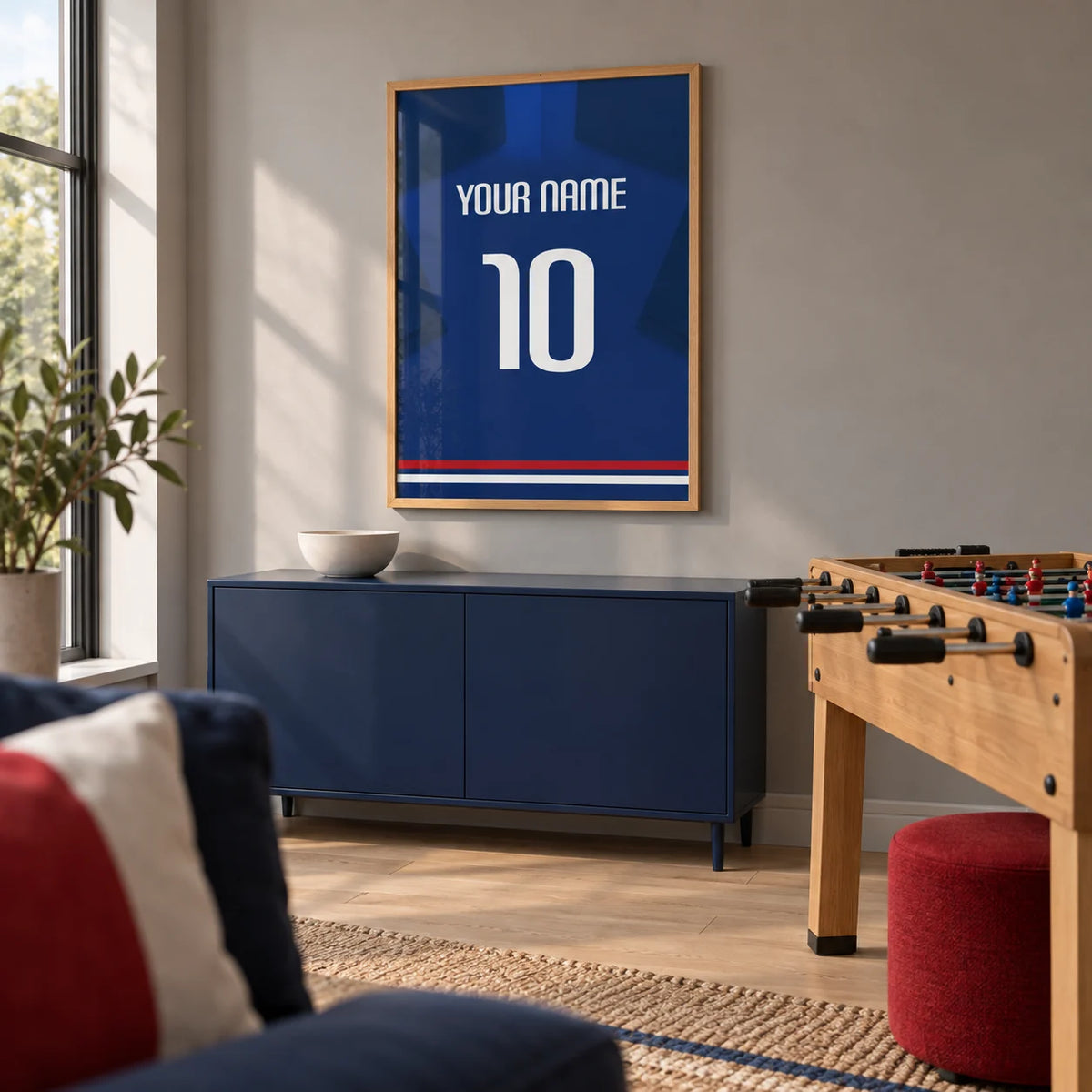 Football Shirt Poster in Plain Blue with White Number, framed on the wall of a contemporary games room in a UK family home with a warm grey wall and pale oak floor