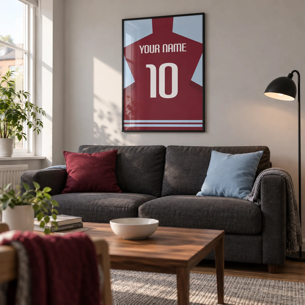Football Shirt Poster in Plain Claret with White Number, framed on the wall of a bright living room in a football fan's first UK flat (22-28) with pale grey walls and a walnut coffee table