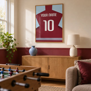 Football Shirt Poster in Plain Claret with White Number, framed on the wall of a football fan's small games snug in a UK family home with a warm white wall and a plain claret painted lower wall in a living room