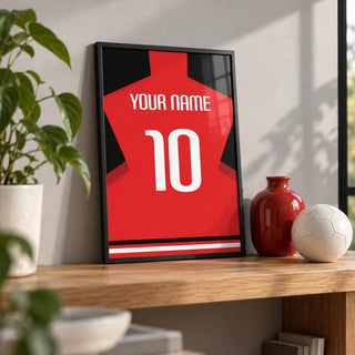 Football Shirt Poster in Plain Red with White Number, a small A4 framed print leaning on an oak shelf in a living room