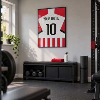 Football Shirt Poster in Red and White Stripes with Black Number, framed on the wall of a neat converted-garage home gym in a UK semi-detached house