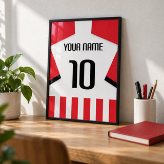 Football Shirt Poster in Red and White Stripes with Black Number, a small A4 framed print leaning on an oak desk