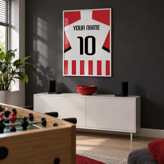 Football Shirt Poster in Red and White Stripes with Black Number, framed on the wall of a small adult games room in a UK family home