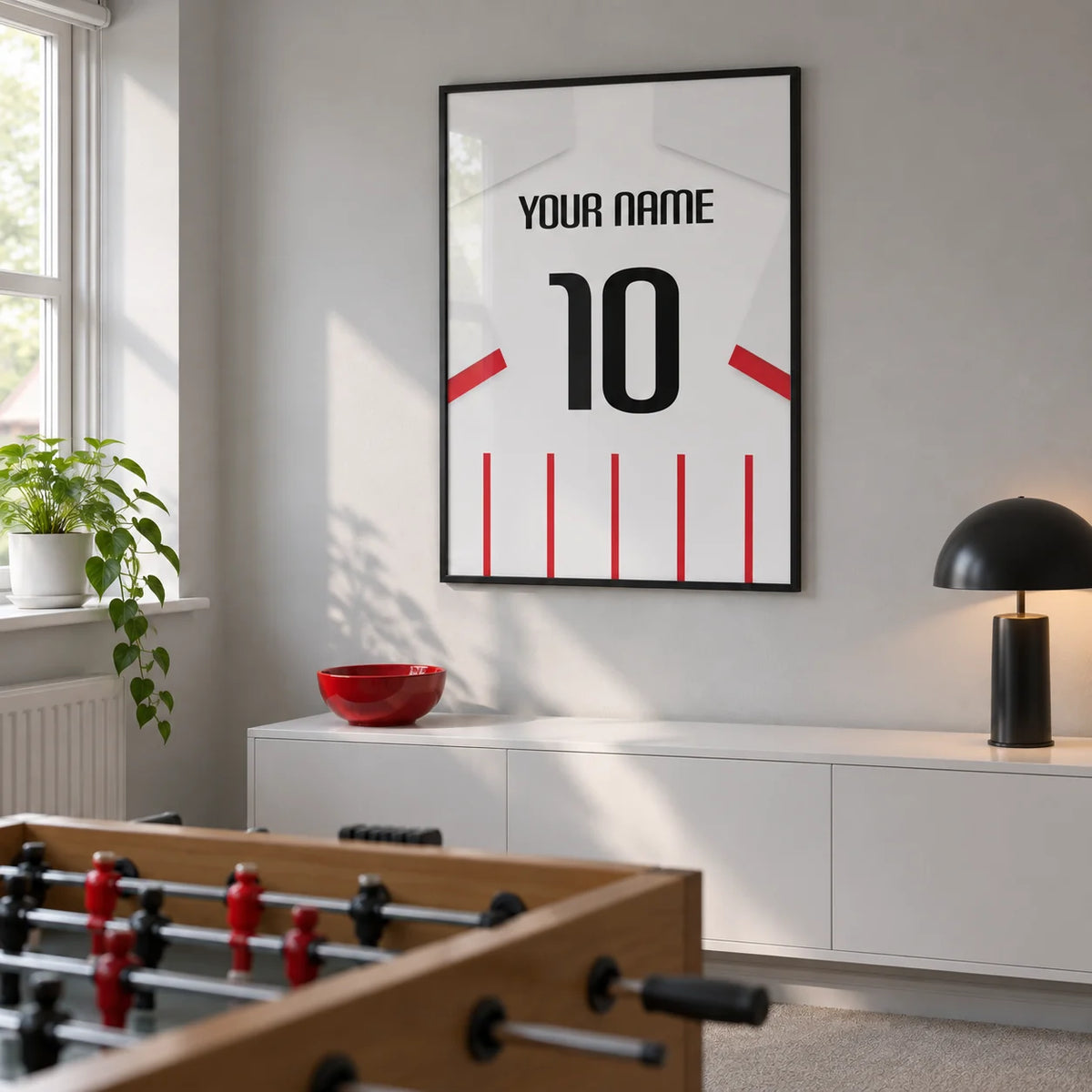 Football Shirt Poster in Red and White Stripes with White Sleeves, framed on the wall of a modest converted spare-room games room in a UK family home with a pale grey wall