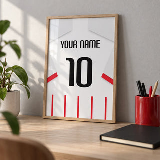 Football Shirt Poster in Red and White Stripes with White Sleeves, a small A4 framed print leaning on a pale oak desk