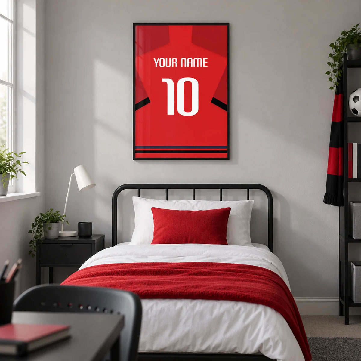 Football Shirt Poster in Red with Black Sleeve Bands, framed on the wall of a modern football-loving teenager's single bedroom (13-17) in a UK family home with a pale grey wall
