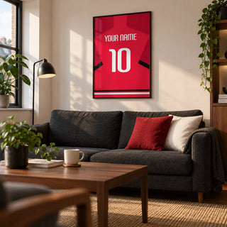 Football Shirt Poster in Red with Black Sleeve Stripe and White Number, framed on the wall of a compact matchday living room in a young adult's first UK flat (22-28)