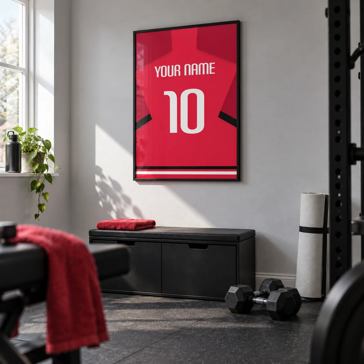 Football Shirt Poster in Red with Black Sleeve Stripe and White Number, framed on the wall of a modest home gym in a converted UK spare room with a light grey wall and black rubber flooring