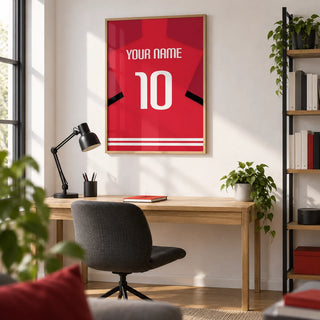 Football Shirt Poster in Red with Black Sleeve Stripe, framed on the wall of a crisp home study for a football fan (22-35) with a white wall and an oak floor