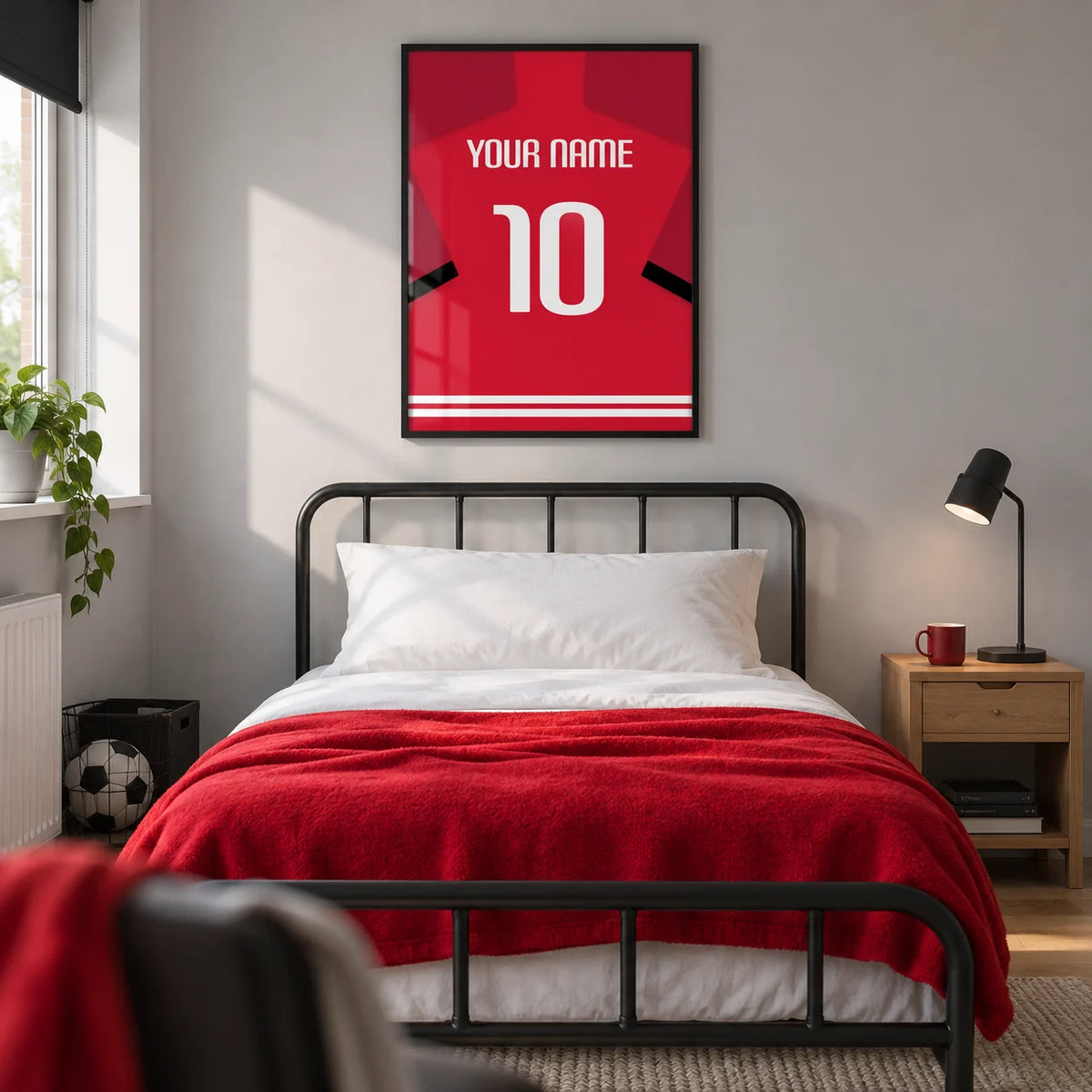 Football Shirt Poster in Red with Black Sleeve Stripe, framed on the wall of a modern football-loving teenager’s single bedroom (13-17) in a UK family home with a pale grey wall and oak floor