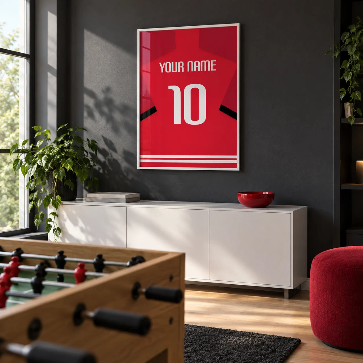 Football Shirt Poster in Red with Black Sleeve Stripe, framed on the wall of a modern games room in a UK family home with a charcoal wall and pale oak floor