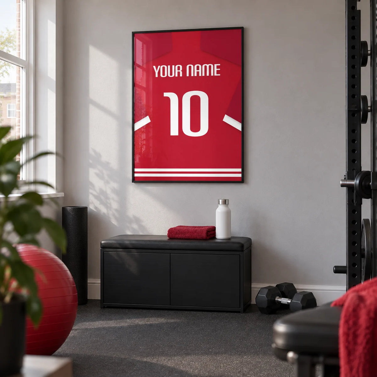 Football Shirt Poster in Red with Bold White 10, framed on the wall of a compact home gym in a UK terraced house with a light grey wall and plain charcoal rubber flooring