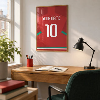 Football Shirt Poster in Red with Green Sleeve Stripe, framed on the wall of a compact home study in a young football fan's UK terraced house