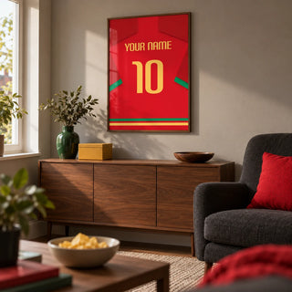 Football Shirt Poster in Red with Green Trim and Yellow Number, framed on the wall of a compact football-viewing snug in a UK semi-detached home with a warm grey wall and walnut furniture in a living room