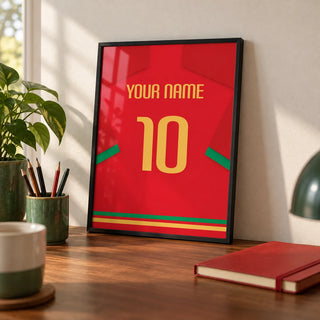 Football Shirt Poster in Red with Green Trim and Yellow Number, a small A4 framed print leaning on a walnut desk