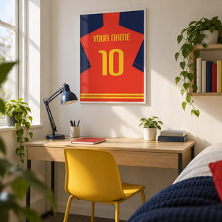 Football Shirt Poster in Red with Navy Sleeves and Yellow Number, framed on the wall of a bright university student's study corner (18-21) in a UK shared house with a white wall
