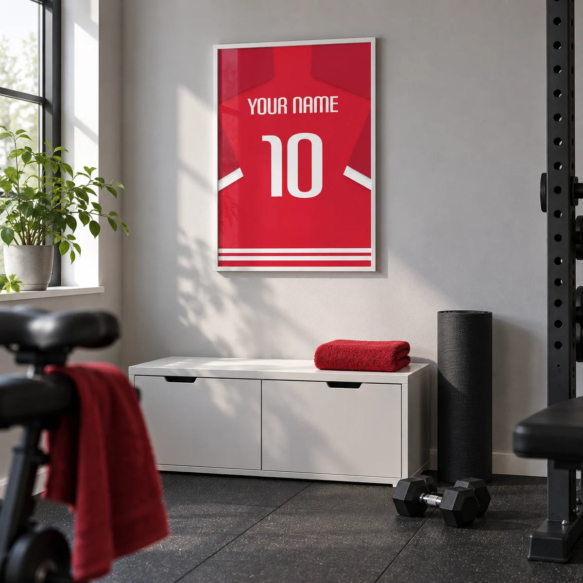 Football Shirt Poster in Red with White Number, framed on the wall of a small converted spare-room home gym with a light grey wall and dark rubber floor