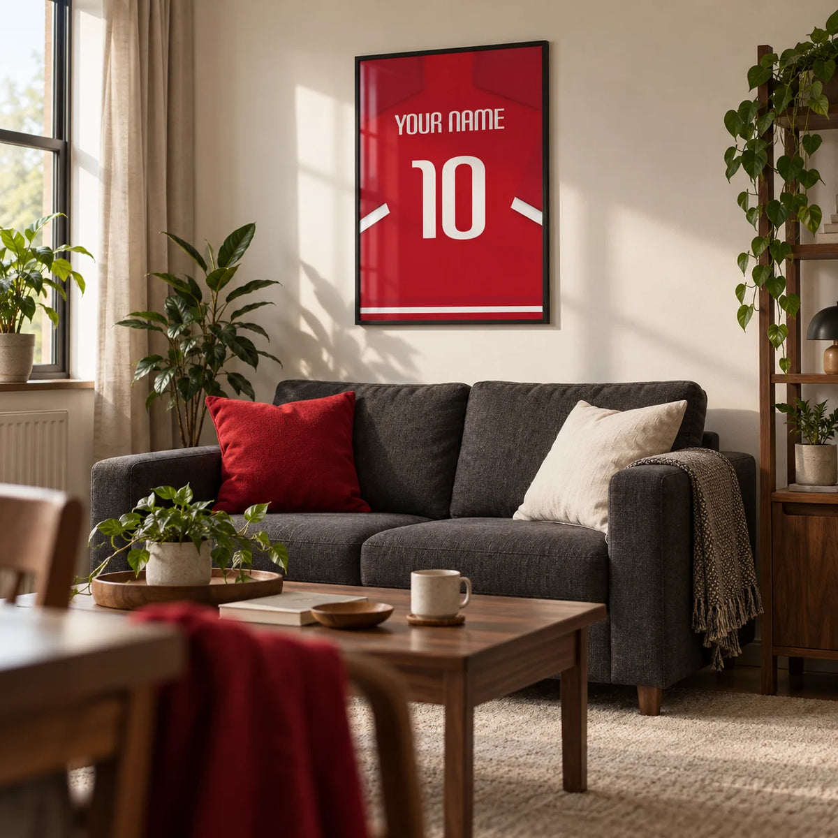 Football Shirt Poster in Red with White Sleeve Stripes, framed on the wall of a compact modern living room in a football fan's first UK flat (22-28)