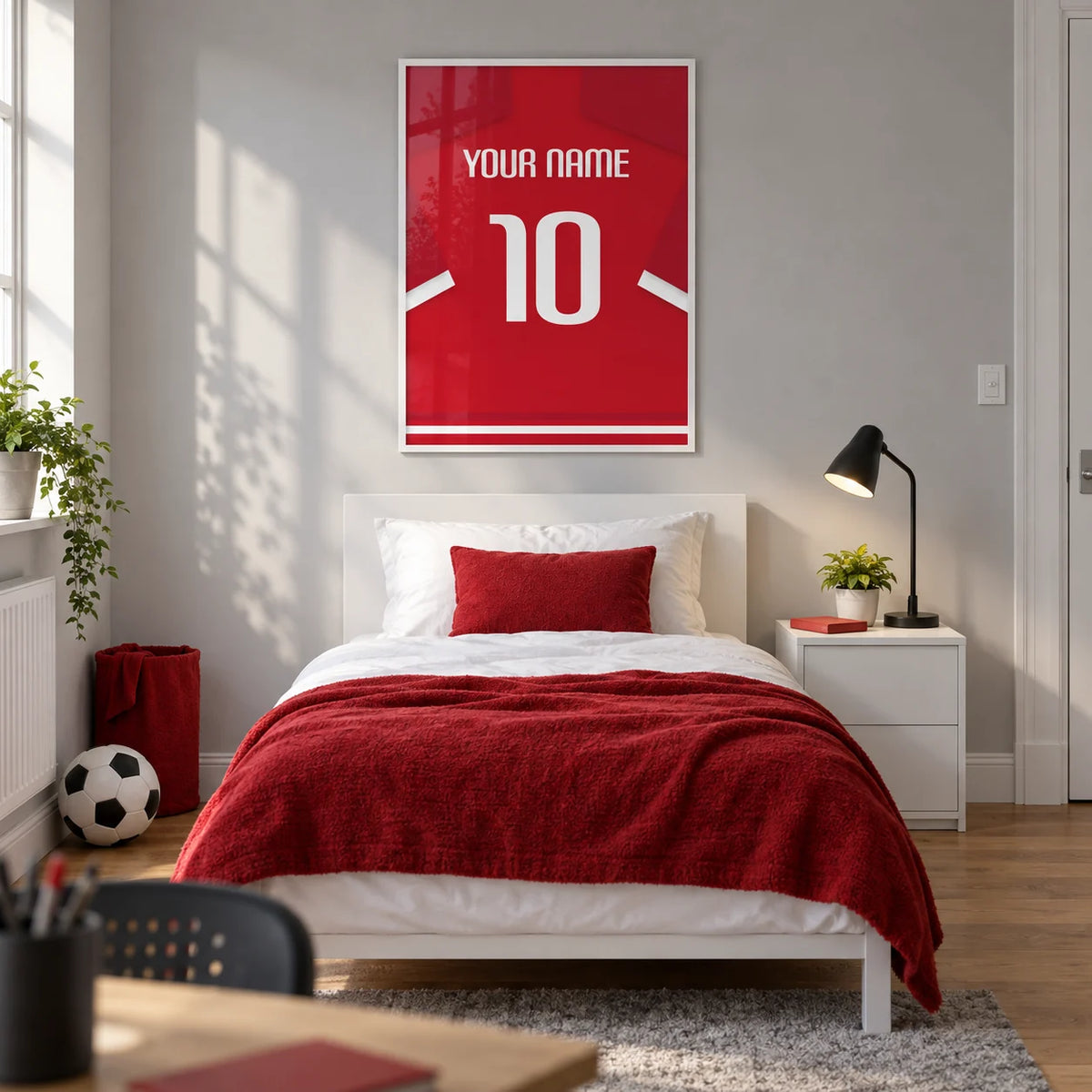 Football Shirt Poster in Red with White Sleeve Stripes, framed on the wall of a modern football-loving teenager's bedroom (13-17) in a UK family home with a pale grey wall and oak floor