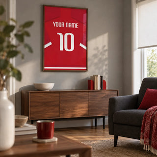 Football Shirt Poster in Red with White Sleeve Stripes, framed on the wall of a small football matchday snug in a UK family home with a muted grey wall and oak floor in a living room