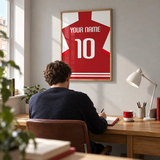 Football Shirt Poster in Red with White Sleeves, framed on the wall of a compact home study in a UK terraced house with a light grey wall