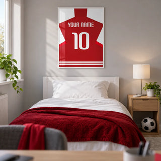 Football Shirt Poster in Red with White Sleeves, framed on the wall of a modern football-loving teenager's single bedroom (13-17) in a UK family home with a pale grey wall