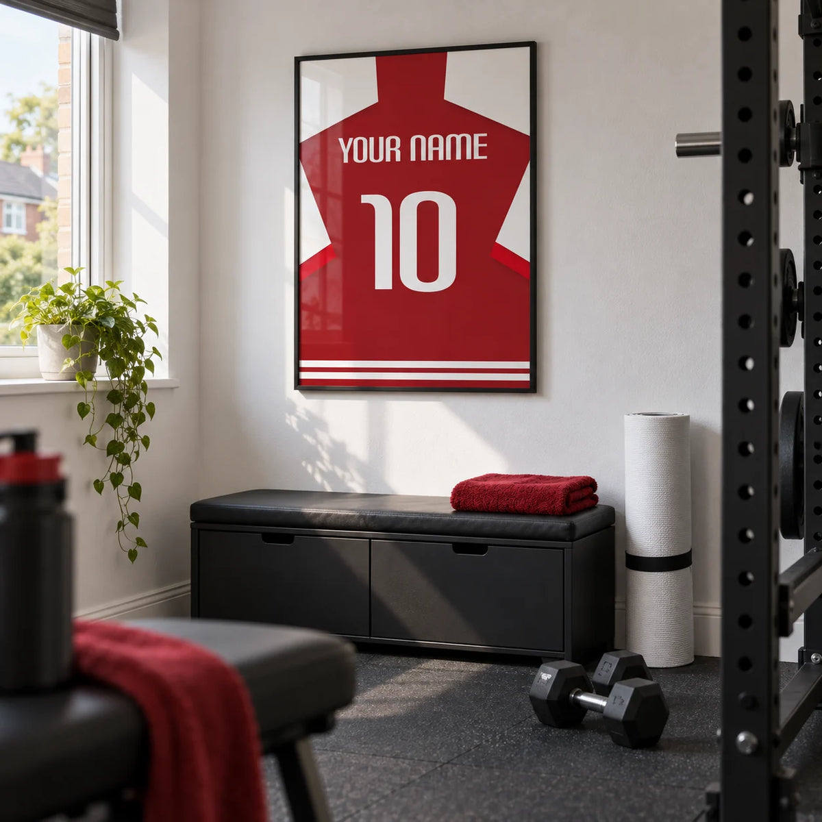 Football Shirt Poster in Red with White Sleeves, framed on the wall of a small converted spare-room home gym in a UK house with white walls and charcoal rubber flooring
