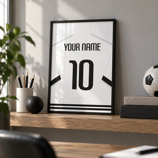 Football Shirt Poster in White with Black Banded Sleeves and Black Number, a small A4 framed print leaning on an oak shelf in a home office